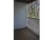 Enclosed patio features wooden floor, white painted wood rails and vinyl siding at 507 Augusta Se Dr, Marietta, GA 30067