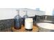 Stylish bathroom featuring dark-colored soap dispensers and candle on a wooden tray at 950 W Peachtree Nw St # 904, Atlanta, GA 30309