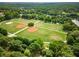 Lush green park with sports fields and recreational areas surrounded by mature trees at 273 12Th Ne St # 210, Atlanta, GA 30309