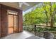 Cozy balcony with brick surround and a view of the surrounding greenery and blue sky at 273 12Th Ne St # 210, Atlanta, GA 30309