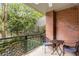 Charming outdoor balcony with brick wall, iron railing, and patio furniture, offering a relaxing outdoor space at 273 12Th Ne St # 210, Atlanta, GA 30309