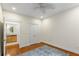 Bright bedroom with hardwood floors, ceiling fan, and view to a bathroom at 273 12Th Ne St # 210, Atlanta, GA 30309