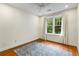 Bright bedroom with hardwood floors, ceiling fan, and a large window at 273 12Th Ne St # 210, Atlanta, GA 30309