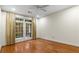 Spacious bedroom features hardwood flooring, neutral paint, ceiling fan and private balcony access at 273 12Th Ne St # 210, Atlanta, GA 30309