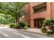 Exterior of the building with red brick facade, landscaping, and covered entry at 273 12Th Ne St # 210, Atlanta, GA 30309