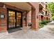 Brick building entrance featuring double glass doors, brick columns, and a paved walkway at 273 12Th Ne St # 210, Atlanta, GA 30309