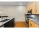 Kitchen with stainless steel faucet, gas range, and light wood cabinetry at 273 12Th Ne St # 210, Atlanta, GA 30309
