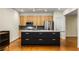 Modern kitchen featuring wood cabinets, stainless steel appliances, and black island at 273 12Th Ne St # 210, Atlanta, GA 30309