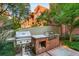 Well-equipped outdoor kitchen with built-in brick grill, landscaping, and access to the main building at 273 12Th Ne St # 210, Atlanta, GA 30309