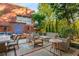 Inviting outdoor patio with comfortable seating, stone and brick flooring, and elegant water feature at 273 12Th Ne St # 210, Atlanta, GA 30309