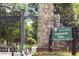 Entrance to Piedmont Park with stone columns, black metal gate, and scooters nearby at 273 12Th Ne St # 210, Atlanta, GA 30309