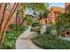 Landscaped walkway leading to the building, with mature trees and manicured greenery at 273 12Th Ne St # 210, Atlanta, GA 30309