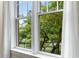 Window view of lush backyard with mature trees and black wrought iron fence at 273 12Th Ne St # 210, Atlanta, GA 30309