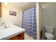 Bathroom featuring a blue patterned shower curtain, white tile countertop, and toilet at 4955 H D Atha Rd, Covington, GA 30014