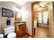 Small bathroom with wooden vanity and laundry access at 4955 H D Atha Rd, Covington, GA 30014