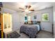 Bright bedroom with a double bed, ceiling fan, and views of the backyard at 4955 H D Atha Rd, Covington, GA 30014