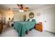 Relaxing bedroom with a green comforter, ceiling fan, and ensuite bathroom access at 4955 H D Atha Rd, Covington, GA 30014
