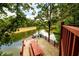 Expansive deck with picnic table overlooks the serene lake, perfect for outdoor dining and entertaining at 4955 H D Atha Rd, Covington, GA 30014