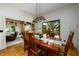 Bright dining room with wood table and chairs, offering views into adjacent living area at 4955 H D Atha Rd, Covington, GA 30014
