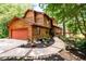 Two story home with wood siding, red door and walkway at 4955 H D Atha Rd, Covington, GA 30014