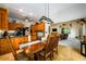 Open concept kitchen with island, wood cabinets, and a view into the living room at 4955 H D Atha Rd, Covington, GA 30014