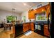 Kitchen boasts granite countertops, wood cabinets, and black appliances at 4955 H D Atha Rd, Covington, GA 30014