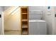 Convenient laundry area with stackable washer/dryer and shelving at 4955 H D Atha Rd, Covington, GA 30014
