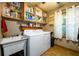 Laundry room with washer, dryer, utility sink, and shelving at 4955 H D Atha Rd, Covington, GA 30014