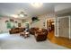 Spacious living room with leather reclining furniture and wood flooring at 4955 H D Atha Rd, Covington, GA 30014