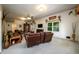 Open living area with leather furniture, hardwood floors, and large windows at 4955 H D Atha Rd, Covington, GA 30014