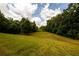 Open field with a view of trees and power lines at 4955 H D Atha Rd, Covington, GA 30014