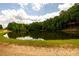 Peaceful pond view with tranquil waters at 4955 H D Atha Rd, Covington, GA 30014