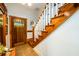 Wooden staircase with white railings in entryway at 4955 H D Atha Rd, Covington, GA 30014