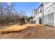 A sloped backyard features a multi-level wood deck, some trees and easy access from the home's sliding glass doors at 556 Rivercrest Dr, Woodstock, GA 30188