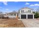 Charming two-story home with a white exterior, black shutters, an attached garage and a front deck at 556 Rivercrest Dr, Woodstock, GA 30188