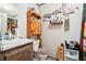 Bathroom with vanity, toilet, and wooden storage cabinet at 127 Cambridge Ct, Hampton, GA 30228