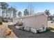 Tan mobile home with a deck, fenced yard, and landscaping at 127 Cambridge Ct, Hampton, GA 30228