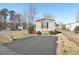 Tan mobile home with a paved driveway and landscaping at 127 Cambridge Ct, Hampton, GA 30228
