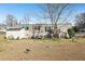 Mobile home's backyard with a shed and spacious yard at 127 Cambridge Ct, Hampton, GA 30228