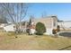 Tan mobile home with a deck and well-maintained lawn at 127 Cambridge Ct, Hampton, GA 30228