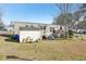 Side view of the mobile home with shed and yard at 127 Cambridge Ct, Hampton, GA 30228