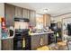 Compact kitchen featuring wooden cabinets and appliances at 127 Cambridge Ct, Hampton, GA 30228
