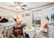 Main bedroom with a ceiling fan and access to another room at 127 Cambridge Ct, Hampton, GA 30228