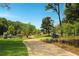 Paved walking trail winding through a park with mature trees at 318 Sandy Springs Cir # 250, Sandy Springs, GA 30328