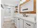 Updated bathroom features white cabinets, quartz countertops, and herringbone floors at 5120 Due West Nw Rd, Kennesaw, GA 30152