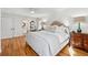 Bright bedroom with hardwood floors, a queen-size bed, and an ensuite bathroom at 5120 Due West Nw Rd, Kennesaw, GA 30152