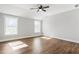 A bedroom with wood-look floors, a ceiling fan and two sunny windows at 629 Elmwood St, Canton, GA 30114