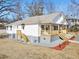 White house with wooden porch and landscaping at 629 Elmwood St, Canton, GA 30114