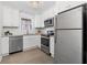 Modern kitchen with white cabinets, granite countertops, and stainless steel appliances at 1230 Piedmont Ne Ave # 405, Atlanta, GA 30309