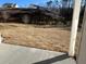 Expansive backyard with a gently sloping hill and a view of neighboring houses at 1109 Cooks Farm Way, Woodstock, GA 30189